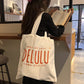 The Daydreamer Canvas orange typography tote bag, view 2